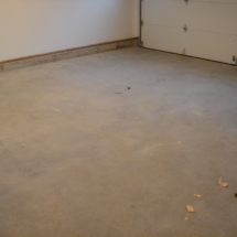 A garage floor that has been cleaned and is ready for painting.
