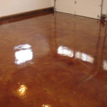 A garage floor that has been stained with brown.