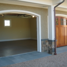 A garage with two doors and a driveway.