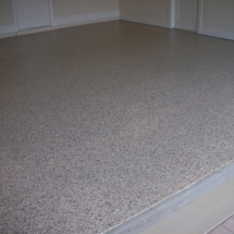 A white floor with some brown and grey speckles