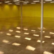 A room with yellow walls and a metal pole.