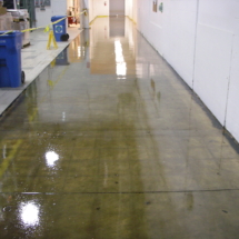 A hallway with water running down the center of it.