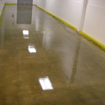 A room with water on the floor and yellow lines.