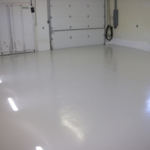 A white garage floor with no one in it.