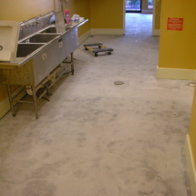 A kitchen with dirty floors and walls
