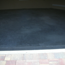 A black mat on the floor of an empty room.