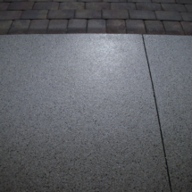 A close up of the floor and brick walkway.