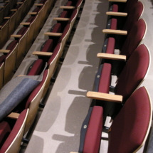 A row of empty seats in an auditorium.