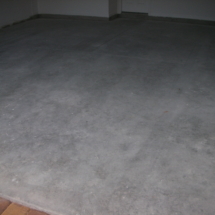 A white carpet on the floor of a room.