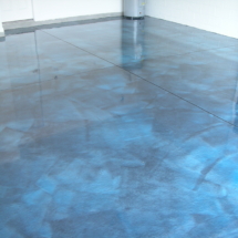 A blue floor with some kind of water on it