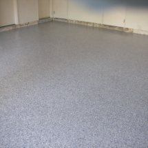 A room with a floor that has been painted grey.