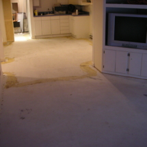 A kitchen with the floor being remodeled.