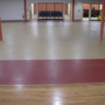 A room with red and white floors and wooden floor.