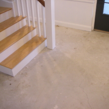 A view of the stairs and floor in a house.