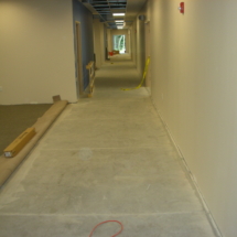 A hallway with concrete floors and walls.