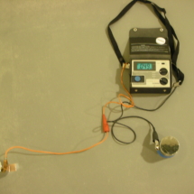 A radio with an antenna and wires attached to it.