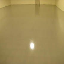 A white floor with a yellow light shining in the center.