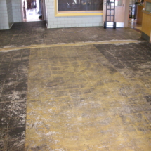 A room with a floor that has been partially covered in mud.