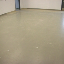 A room with a floor that has been painted gray.
