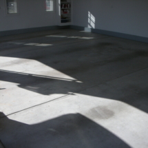 A room with concrete floors and white walls.