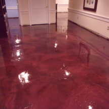 A red floor with water on it and white walls