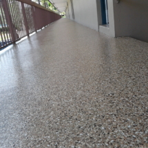 A floor with a large amount of white and brown speckles.
